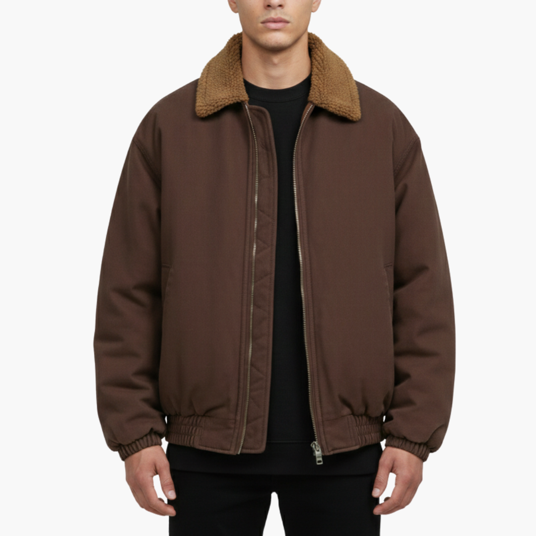 Brown bomber jacket featuring a front zipper, padded design, stand collar, and elastic hems.