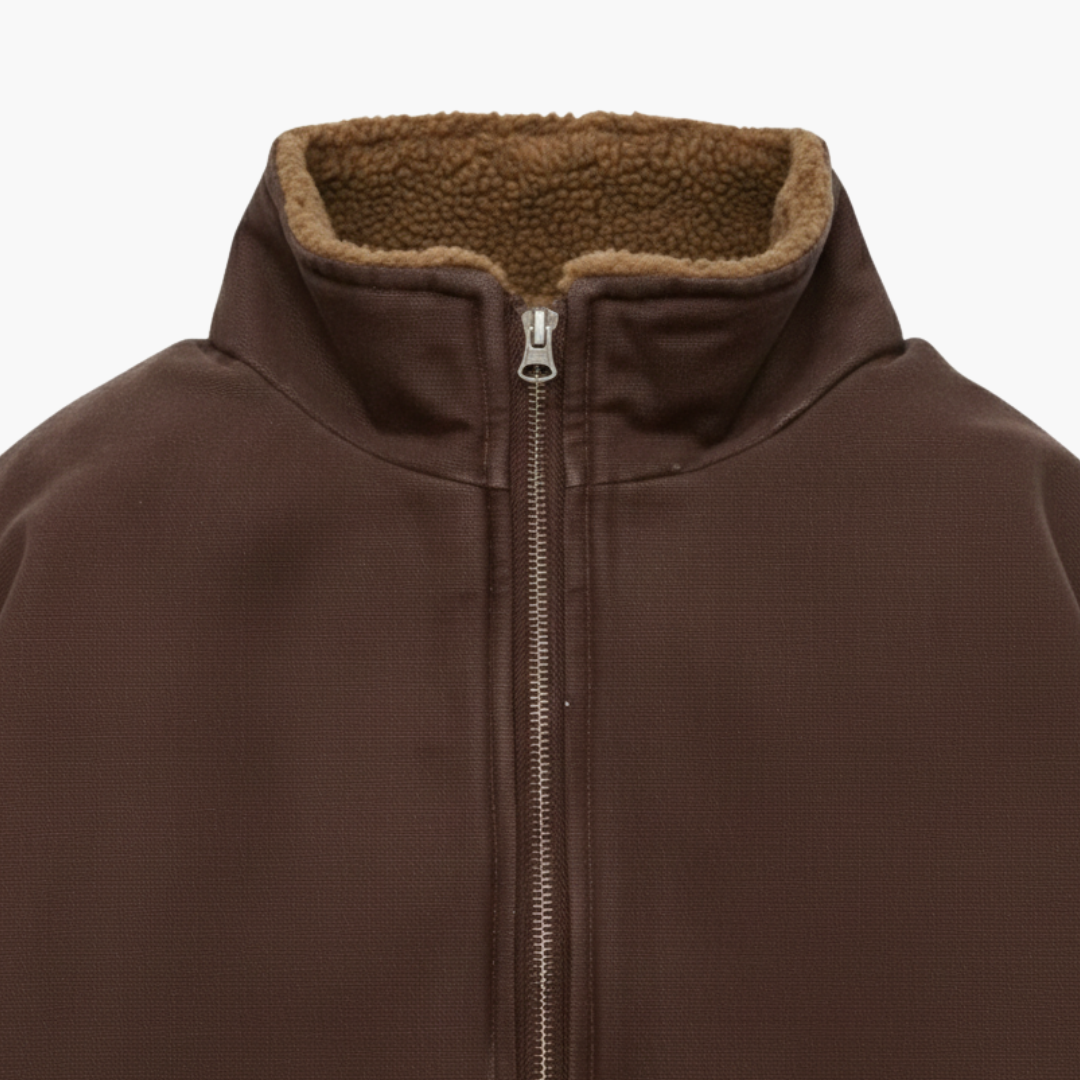 Brown bomber jacket featuring a front zipper, padded design, stand collar, and elastic hems.