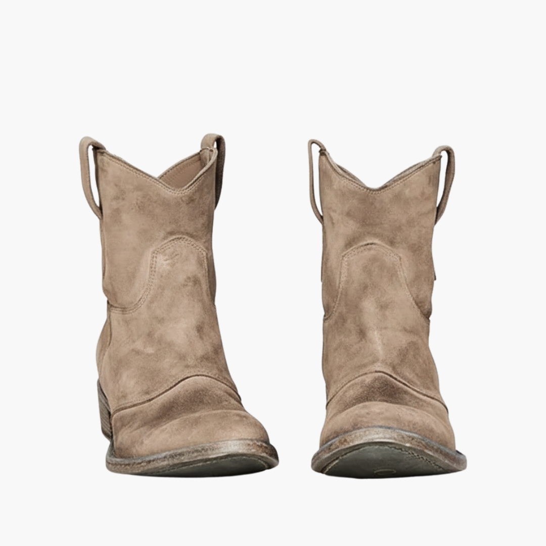 A pair of brown ankle boots featuring a pull-on design and low stacked heel